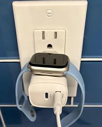 Compact watch charger keeping an outlet setup organized